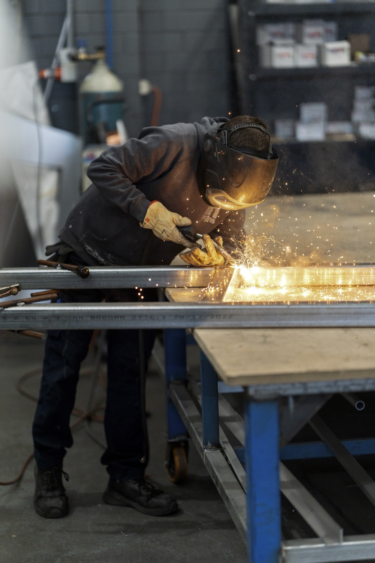 Insigns team member fabricating a steel sign frame in the Braeside workshop