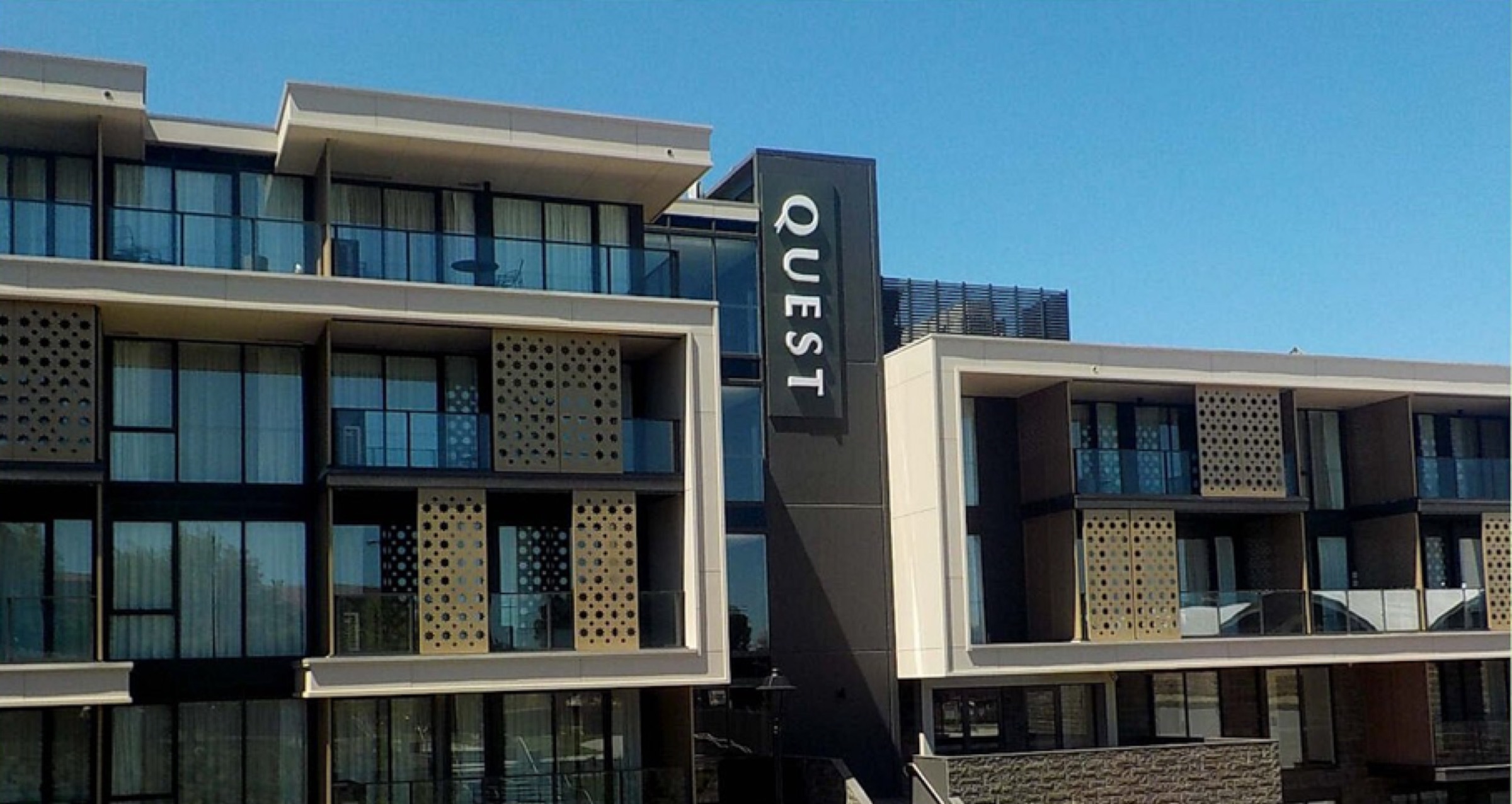 Quest Apartments facade blade sign