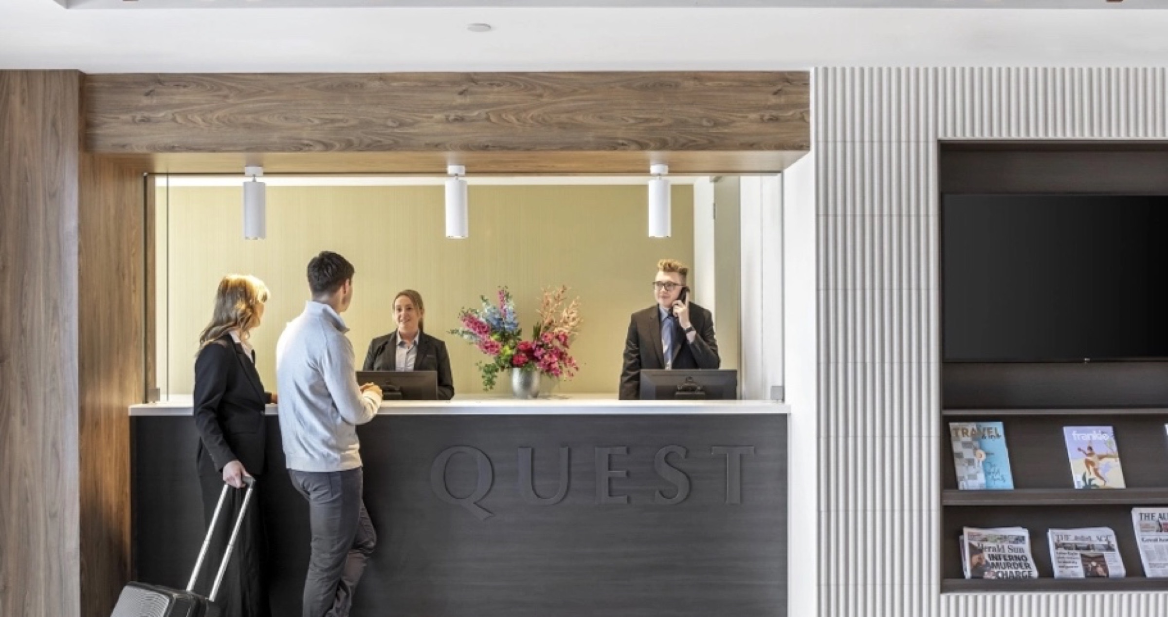 Quest Apartments reception wall signage